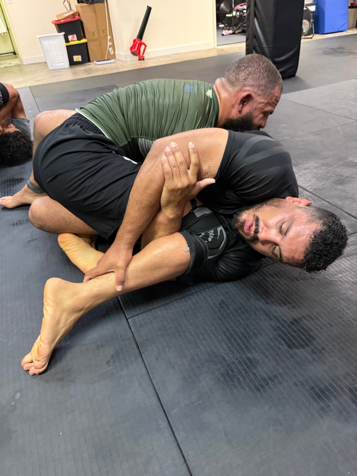 Adults practicing No-Gi Brazilian Jiu-Jitsu during live training at Rolling Bear BJJ