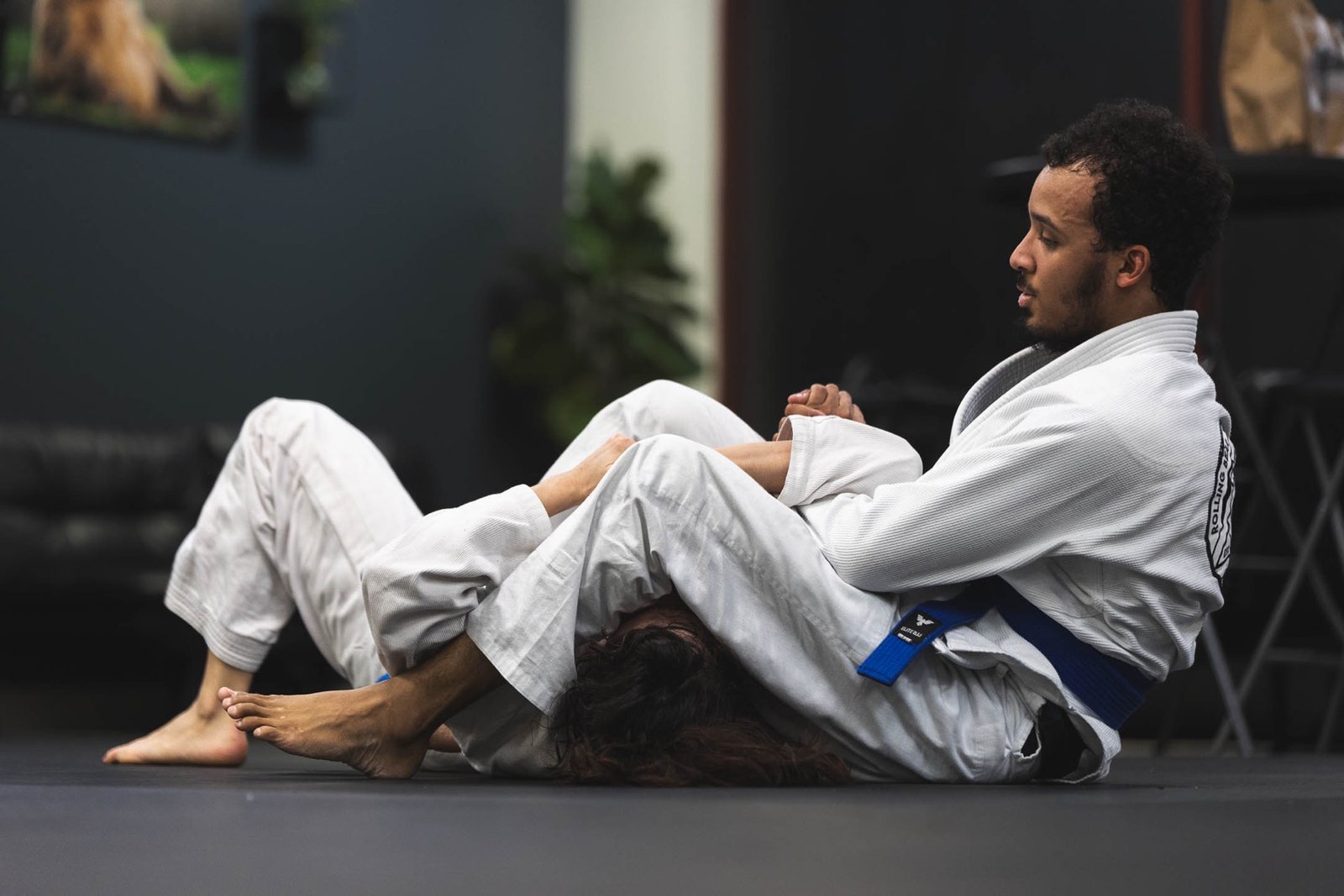 Adult students developing control during Gi Brazilian Jiu-Jitsu training at Rolling Bear BJJ