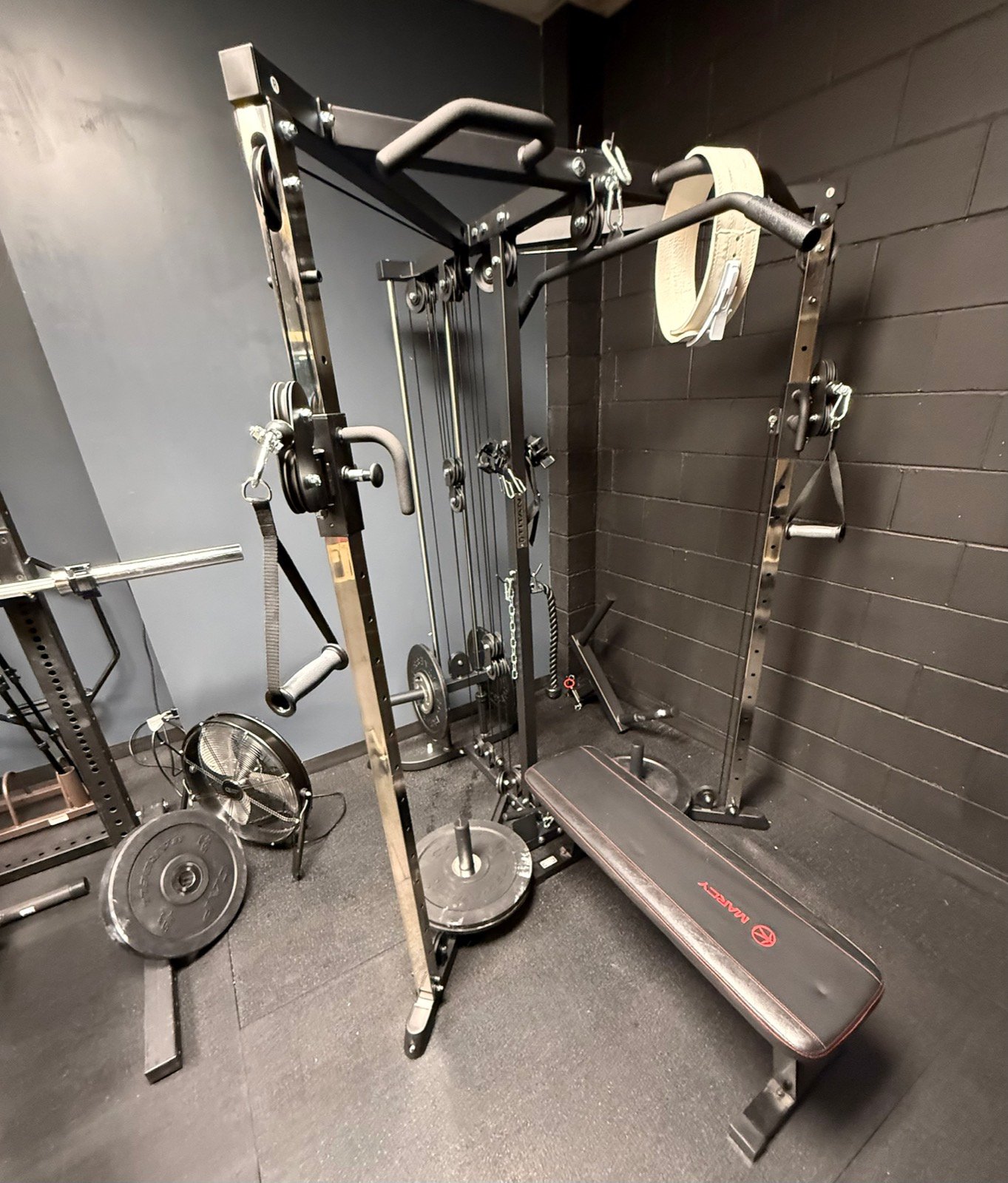 Cable and pulley strength-training station in the Rolling Bear BJJ weight room