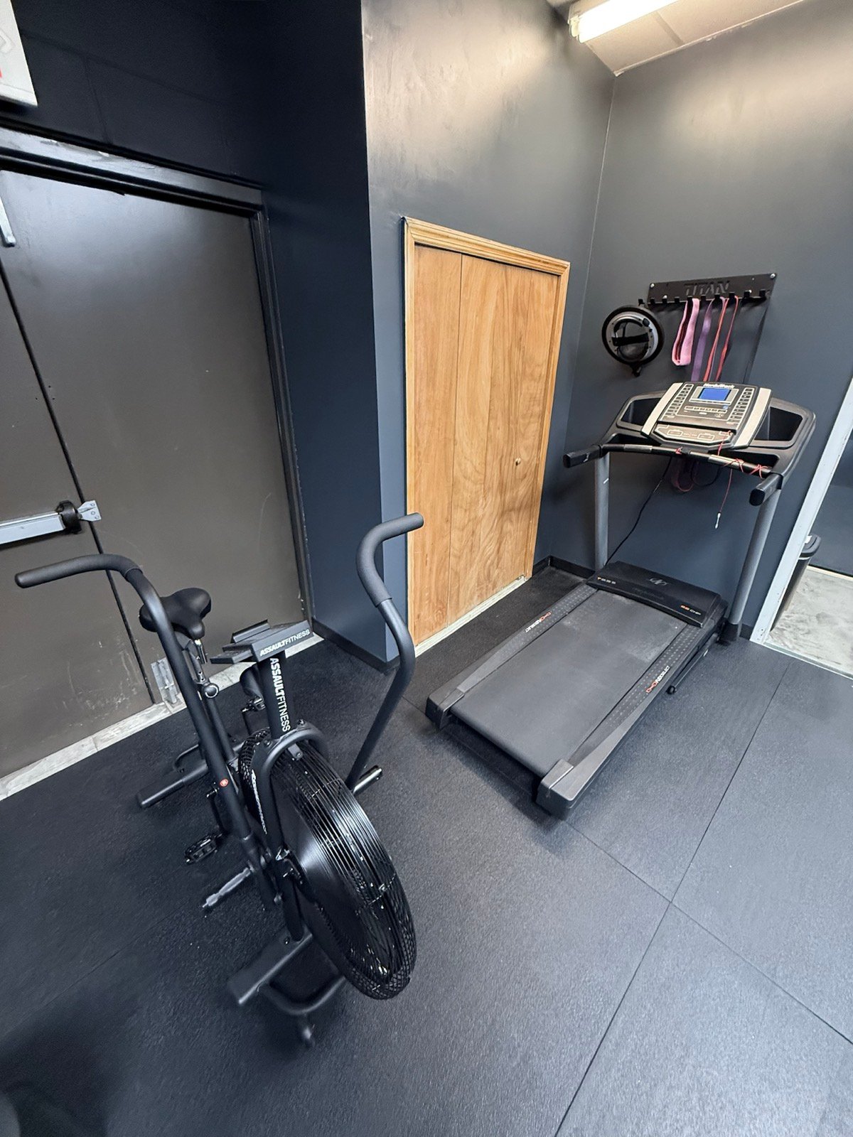 Treadmill and fan bike available in the Rolling Bear BJJ member weight room