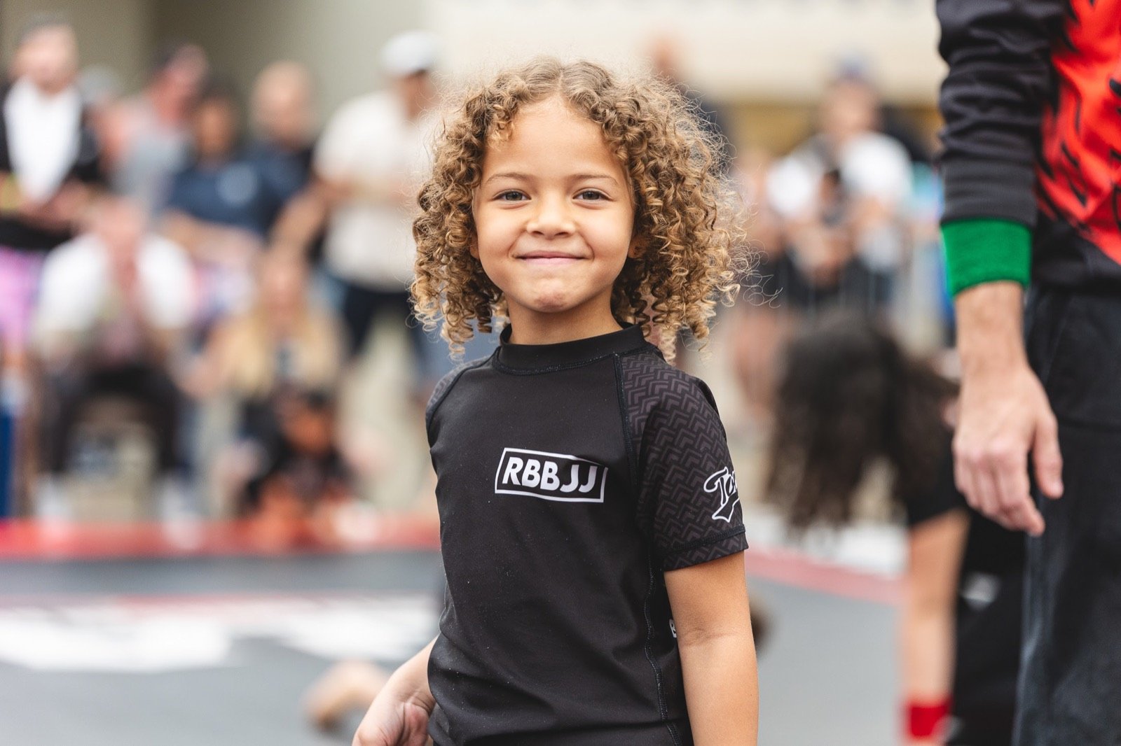 A young Rolling Bear BJJ competitor smiling at a Brazilian Jiu-Jitsu tournament