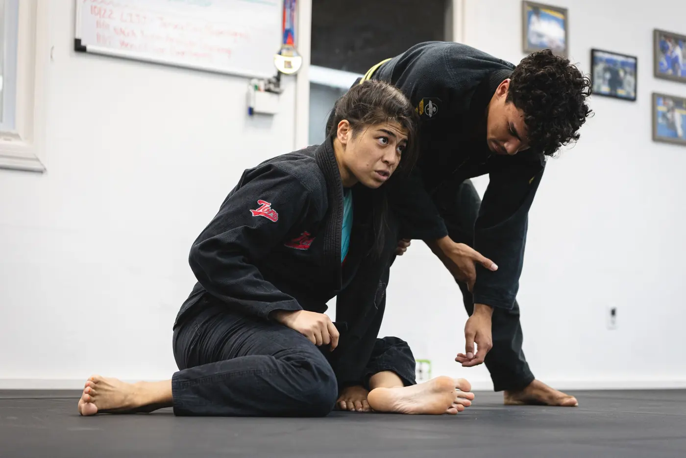 Instructor coaching a student through a guard position at Rolling Bear BJJ