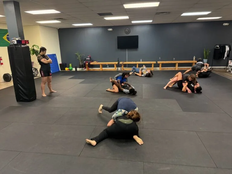 Women practicing Brazilian Jiu-Jitsu technique at Rolling Bear BJJ