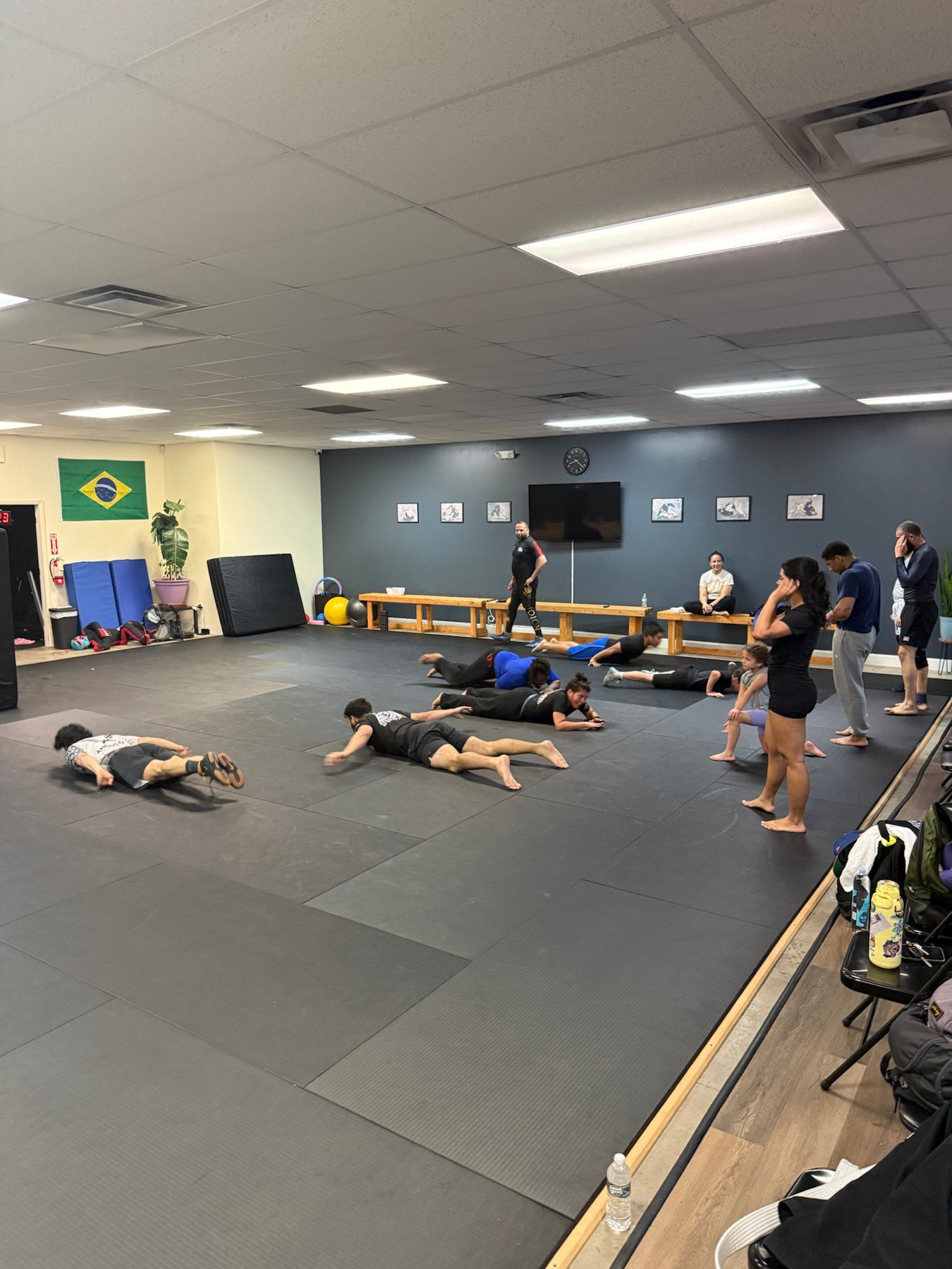 Adults performing wrestling warmup drills at Rolling Bear BJJ